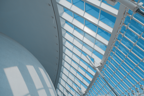 Free Abstract view of a modern architectural glass roof against a clear blue sky. Stock Photo