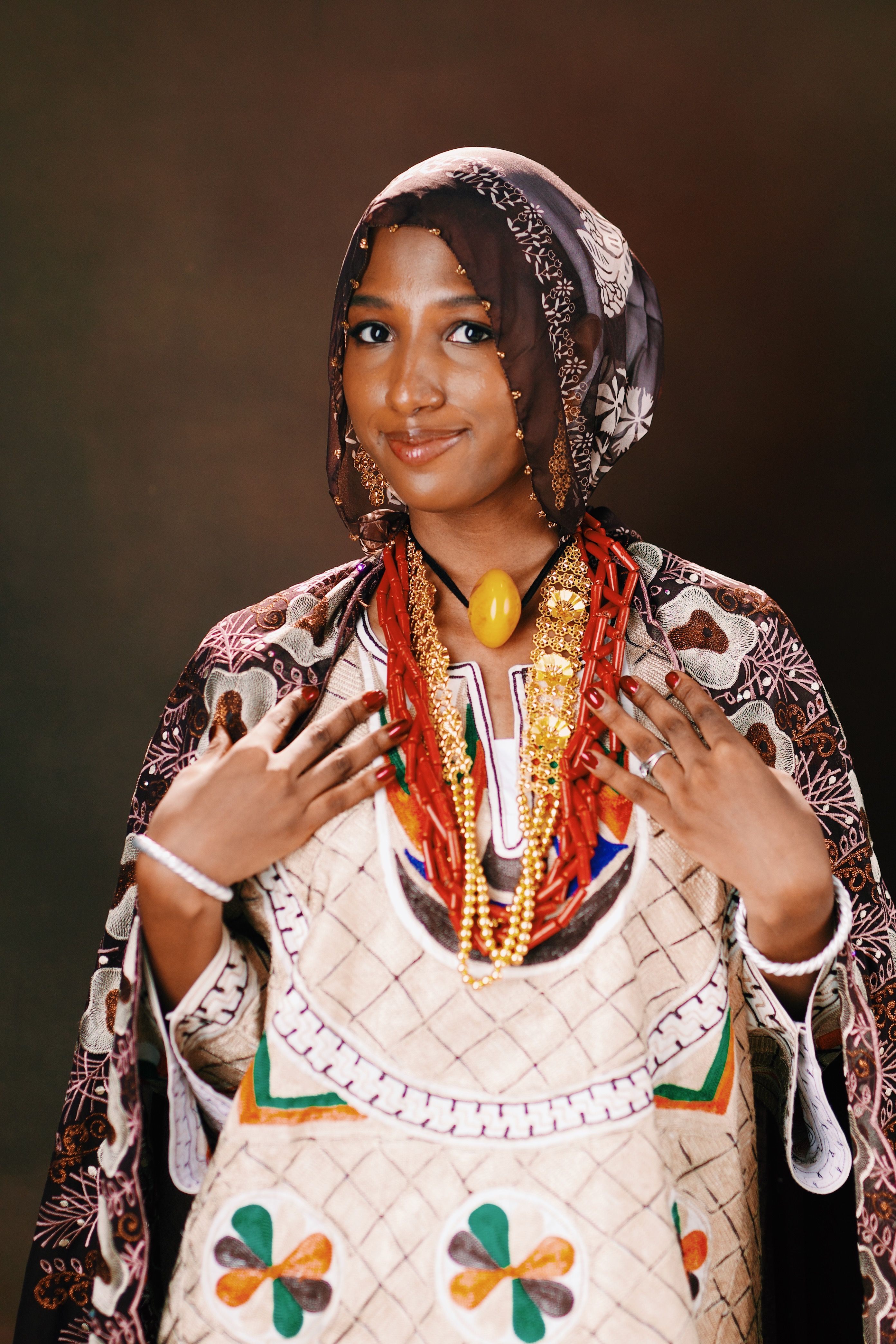 Elegant portrait of a woman wearing traditional attire and vibrant jewelry, exuding cultural richness.