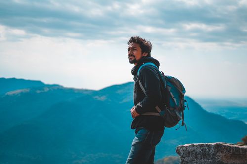 Free Man enjoying a scenic mountain view in India, capturing the essence of adventure and travel. Stock Photo