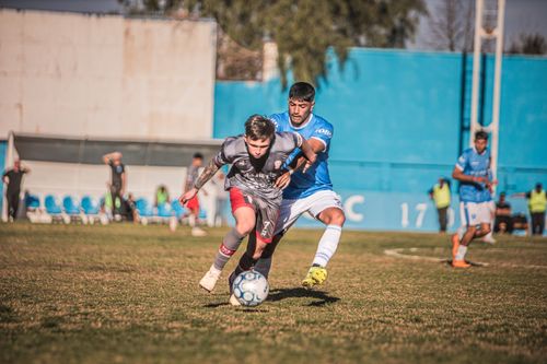 Free Two soccer players in a competitive moment during a daytime match outdoors. Stock Photo