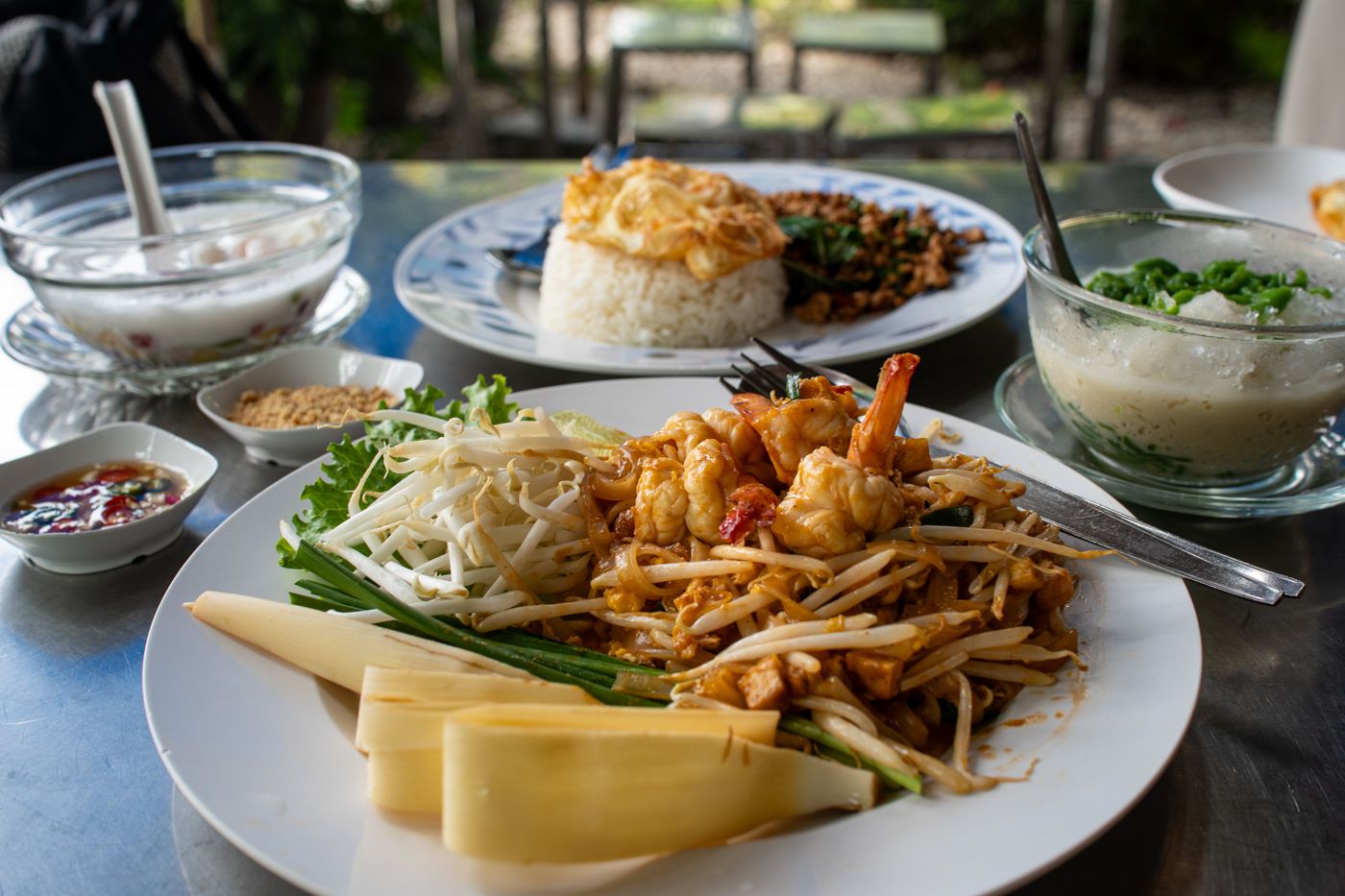 An appetizing spread of traditional Thai dishes including Pad Thai and rice.