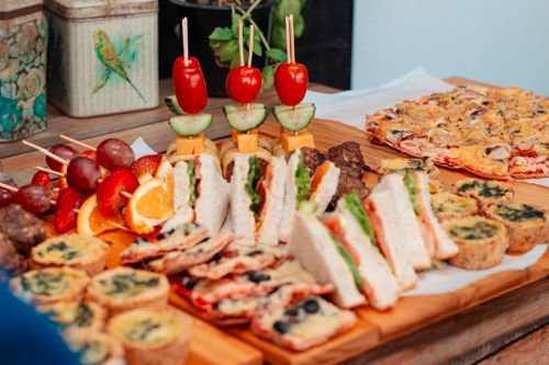 Free A vibrant buffet table filled with sandwiches, skewers, and various snacks, perfect for outdoor gatherings. Stock Photo