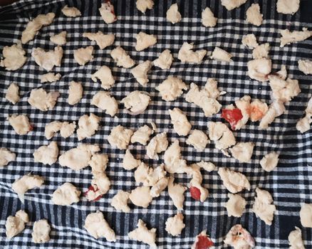 Fresh homemade paprika chips drying on a blue checkered cloth, adding rustic charm.