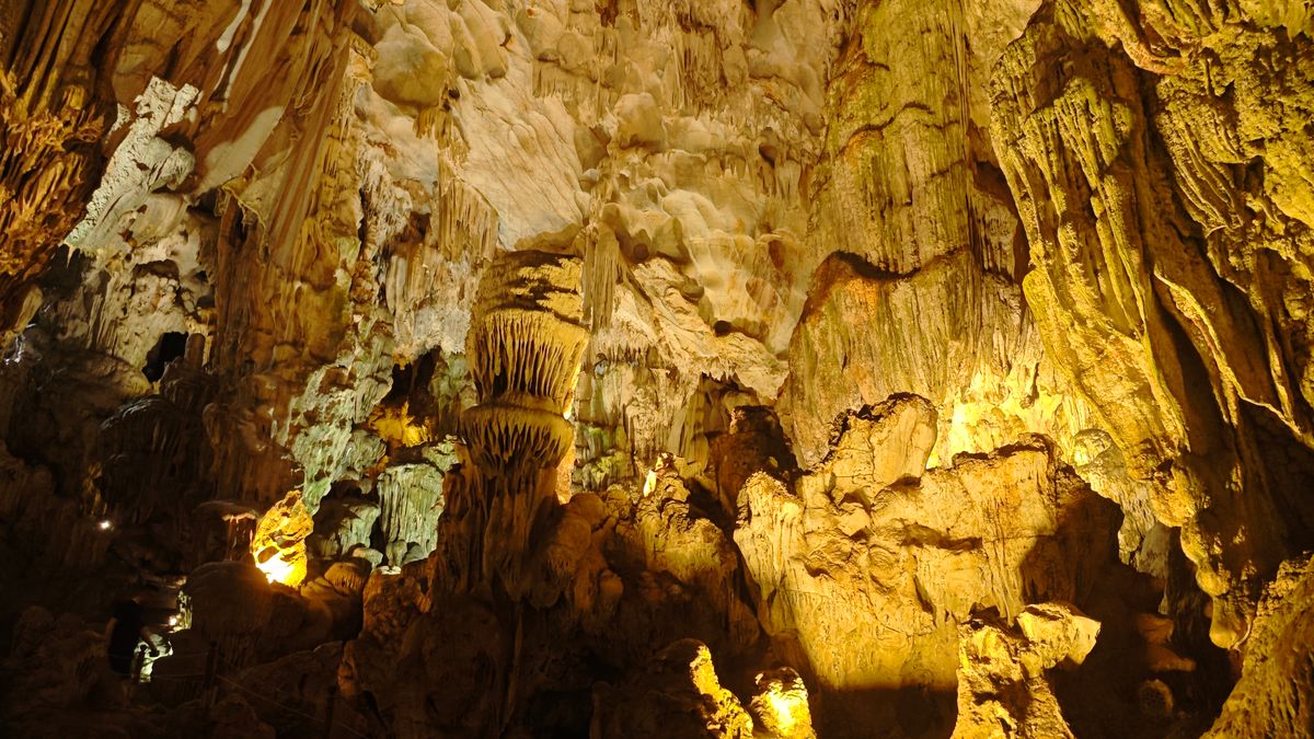Explore the stunning limestone formations inside a cave in Ha Long Bay, Vietnam.