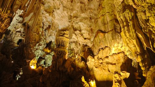 Free Explore the stunning limestone formations inside a cave in Ha Long Bay, Vietnam. Stock Photo