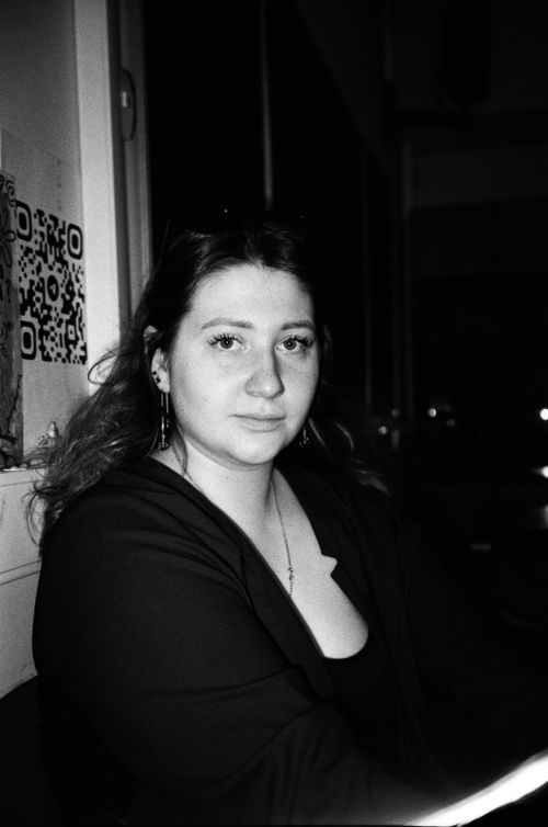 Free A moody black and white portrait capturing a young woman indoors at night. Stock Photo