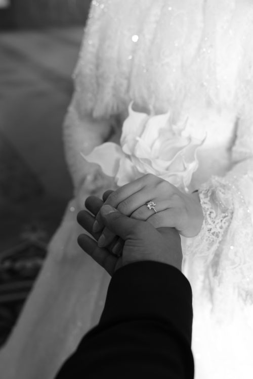 Free Black and white photo of a romantic wedding moment with a focus on hands. Stock Photo