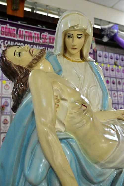 Free Detailed view of a Pietà sculpture portraying a religious scene indoors. Stock Photo