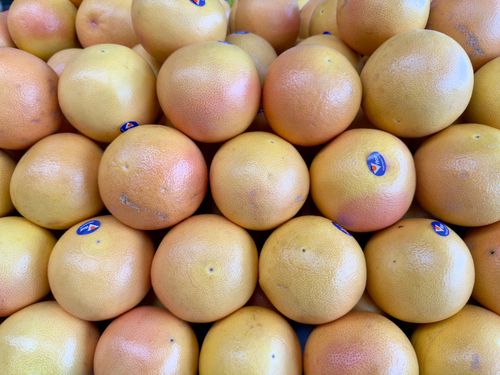 Free A vibrant stack of fresh grapefruits on display at a market in Maribyrnong, Victoria. Stock Photo