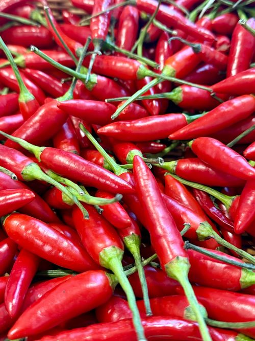Free Close-up of fresh, vibrant red chili peppers. Ideal for culinary and spice-themed visuals. Stock Photo