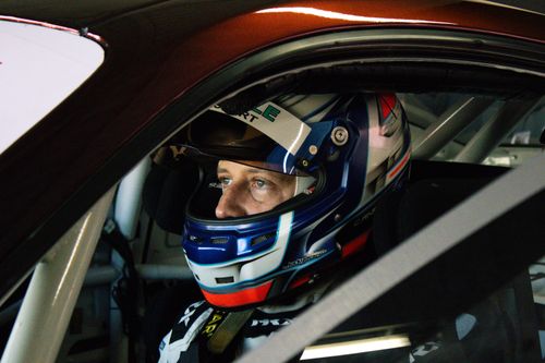 Free Portrait of a focused race car driver in helmet inside the vehicle cockpit, showcasing determination and intensity. Stock Photo