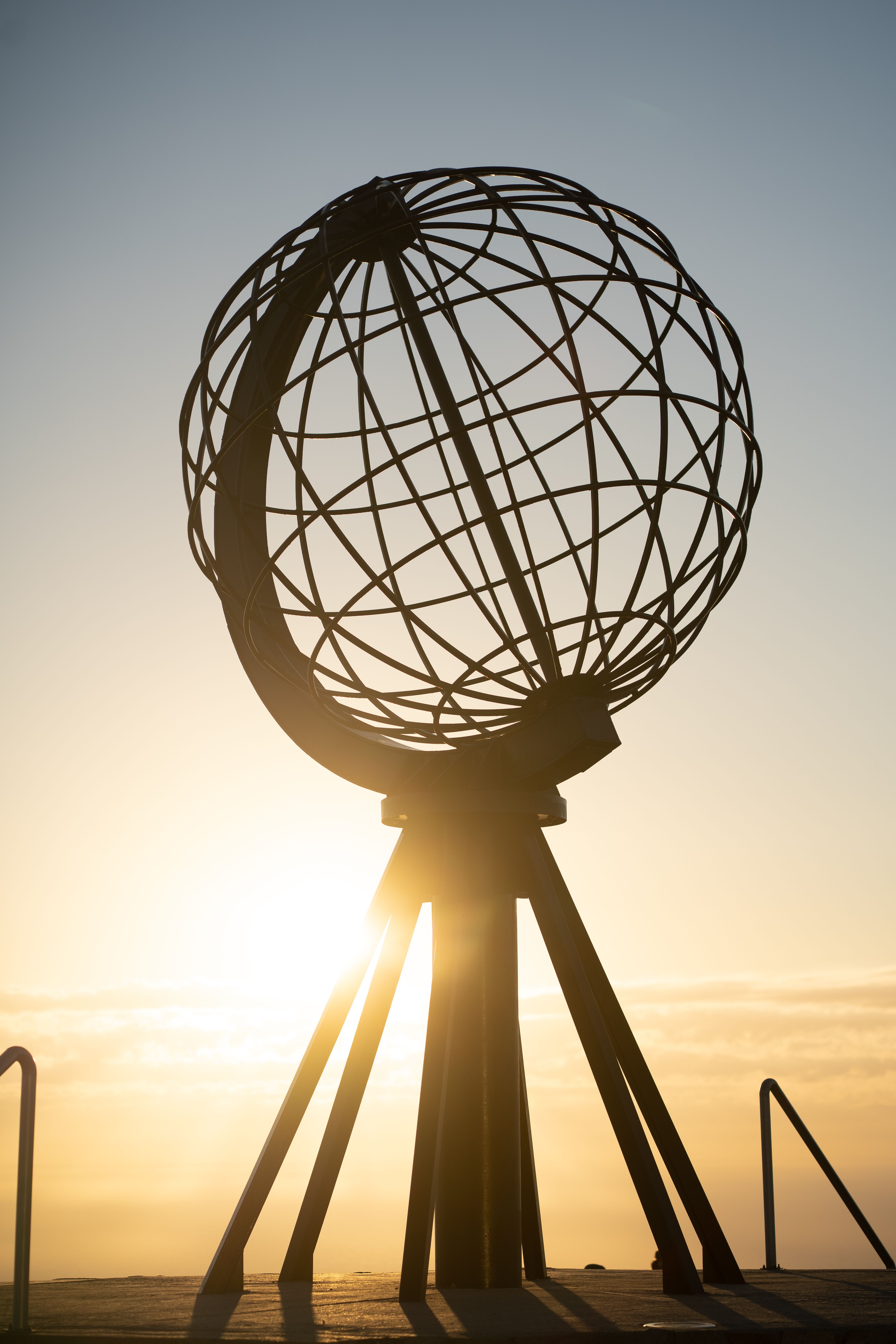 The iconic North Cape Globe Monument silhouetted by a stunning sunrise in Norway.