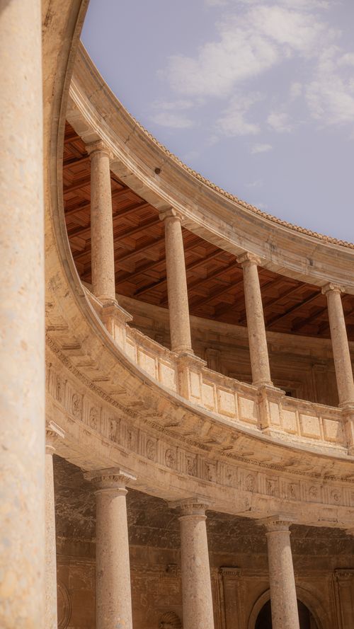Free Explore the stunning circular colonnade inside the Palace of Charles V in Granada, Andalusia, Spain. Stock Photo