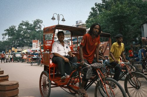 Free A busy street scene in Delhi, India, featuring a traditional rickshaw and bustling urban life. Stock Photo