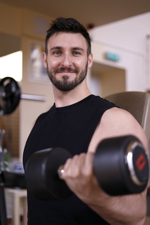 Man in Black Crew Neck T-shirt Holding A Dumbbell