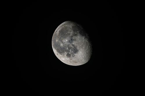 Free Detailed image of the waning gibbous moon against a dark sky, highlighting its craters and surface texture. Stock Photo
