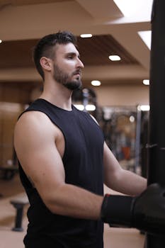 Man focused on workout in gym, showcasing strength and determination.