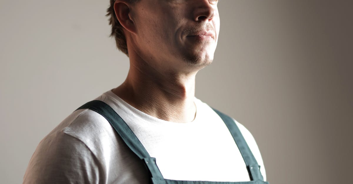 Photo by Andrea Piacquadio Portrait of a confident construction worker in a hard hat, looking forward in studio lighting.