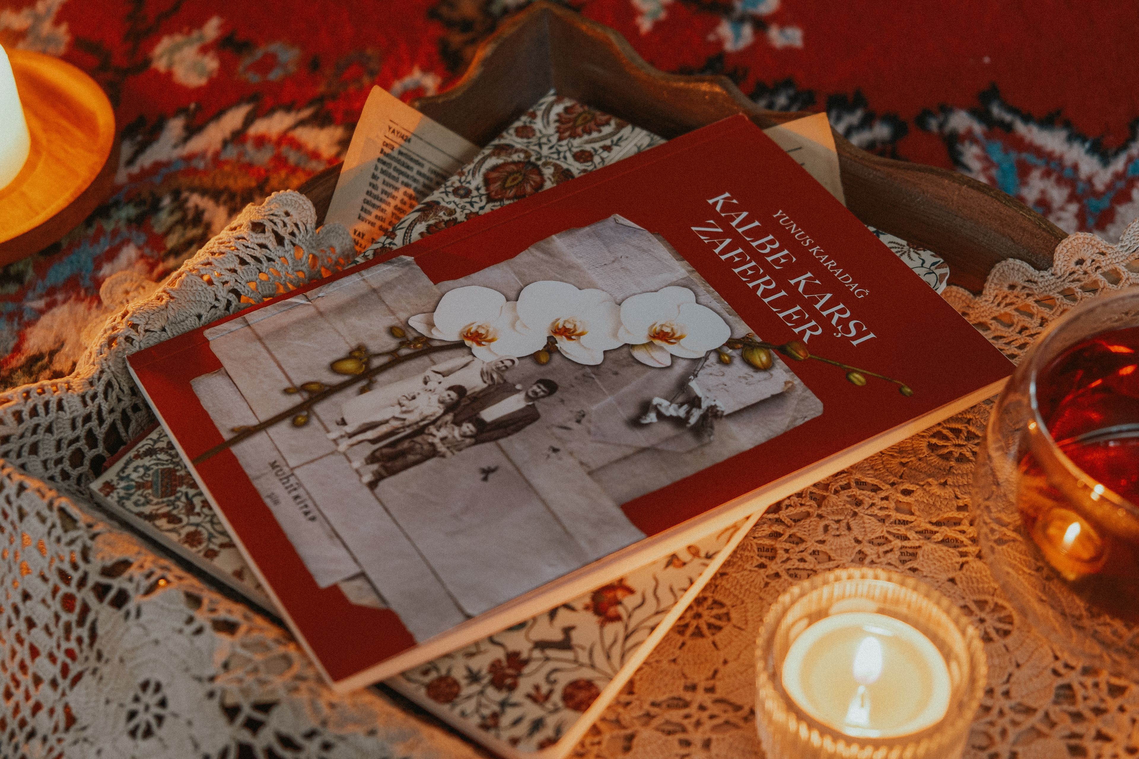 A serene setting with a Turkish book, soothing candlelight, and warm tones, perfect for relaxation.