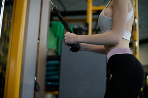 Woman in Gray Tank Top and Black Leggings Doing Exercise