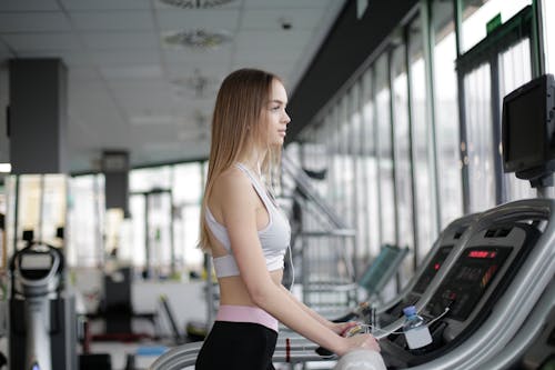 Woman Standing On A Treadmill