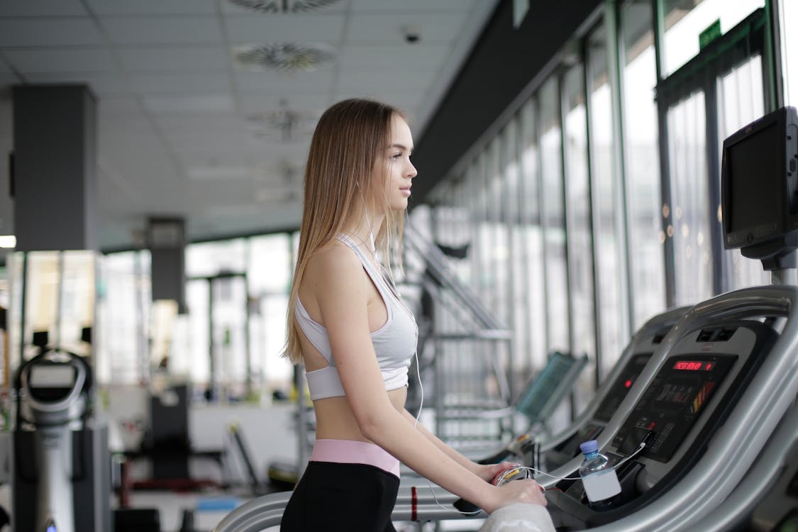 Woman Standing On A Treadmill
