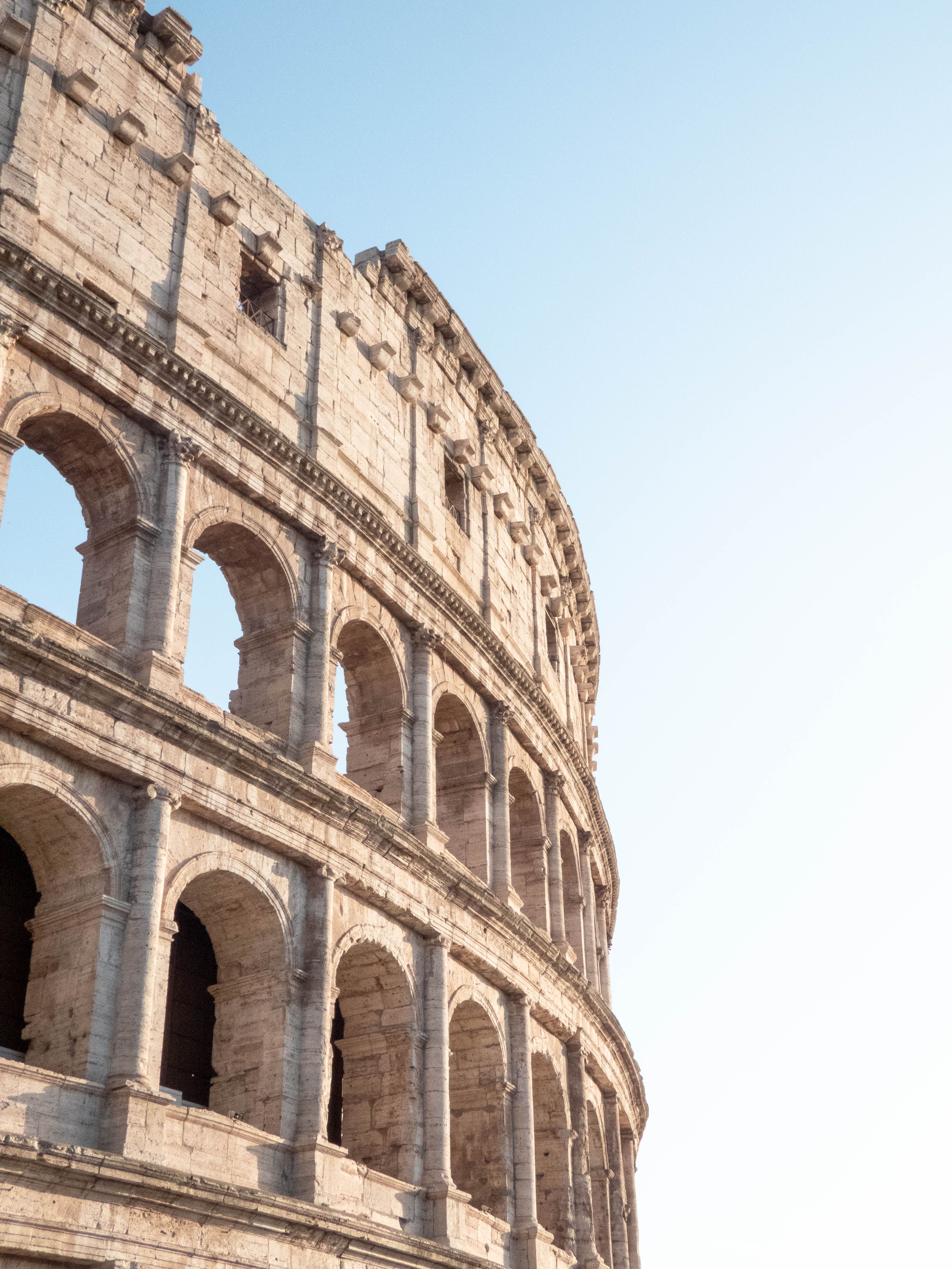 The iconic Colosseum in Rome, Italy, captured beautifully against a clear blue sky.