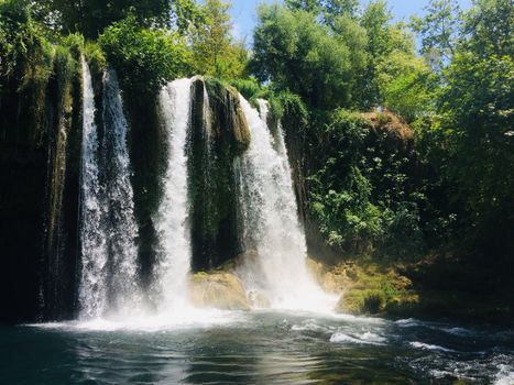 Beautiful waterfall surrounded by lush greenery in Kepez, Antalya, Turkey.