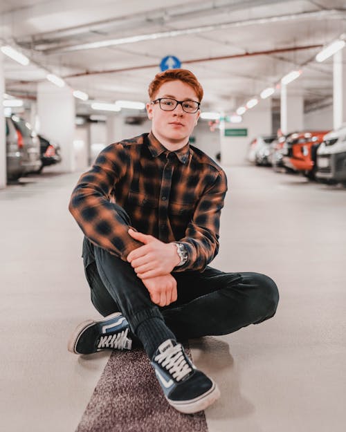 Man Sitting On Parking Area Floor