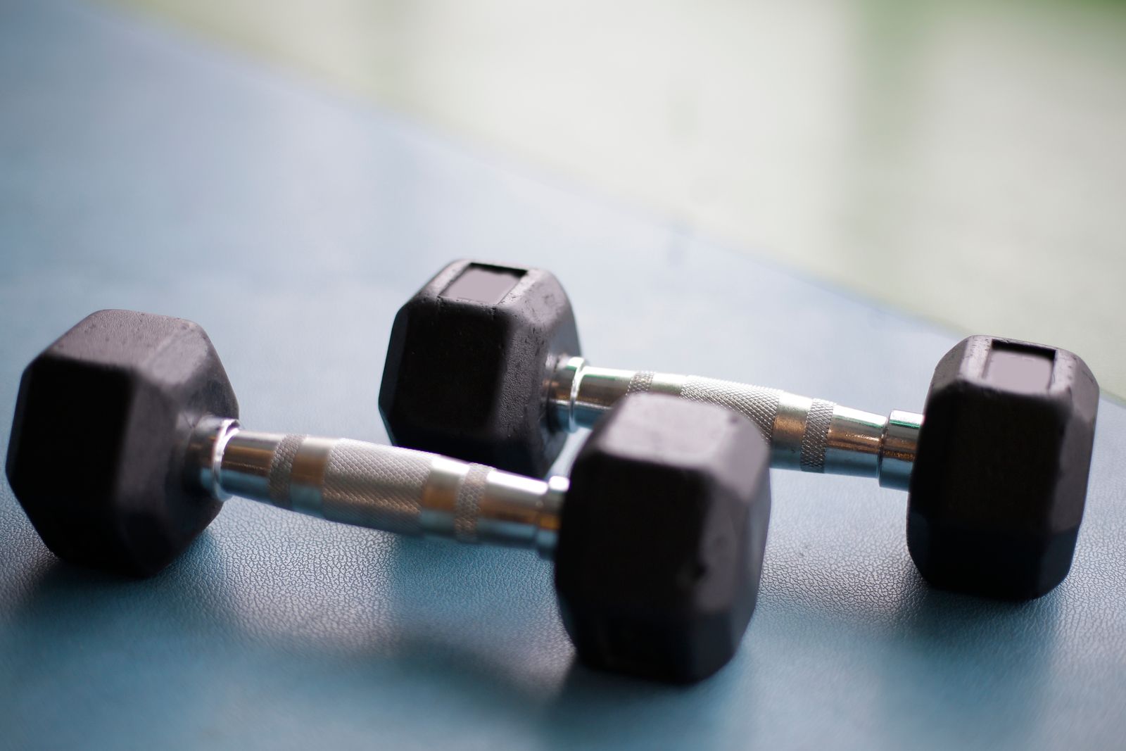 Person performing a squat with a barbell as part of a compound strength movement