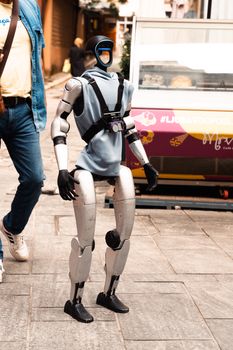 A humanoid robot captured on a bustling street in Sarajevo, Bosnia and Herzegovina.