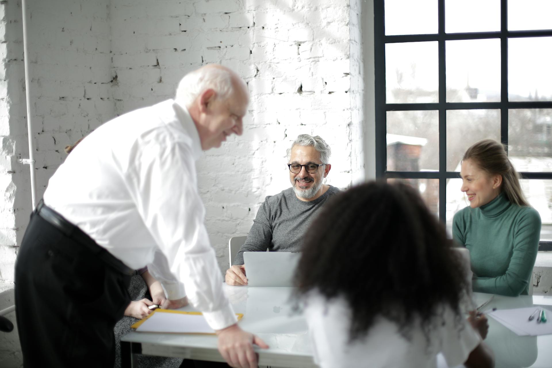 Business team collaborating in a modern office setting. Diverse group involved in a team meeting.