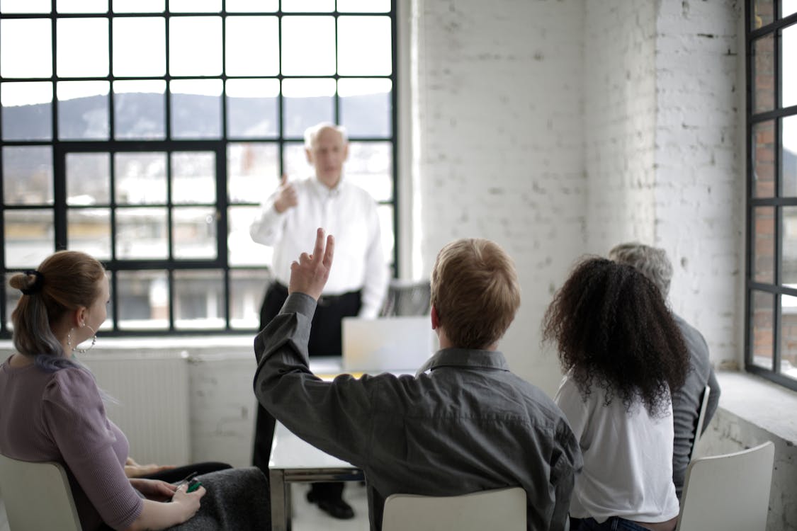 People Having a Discussion in a White Room