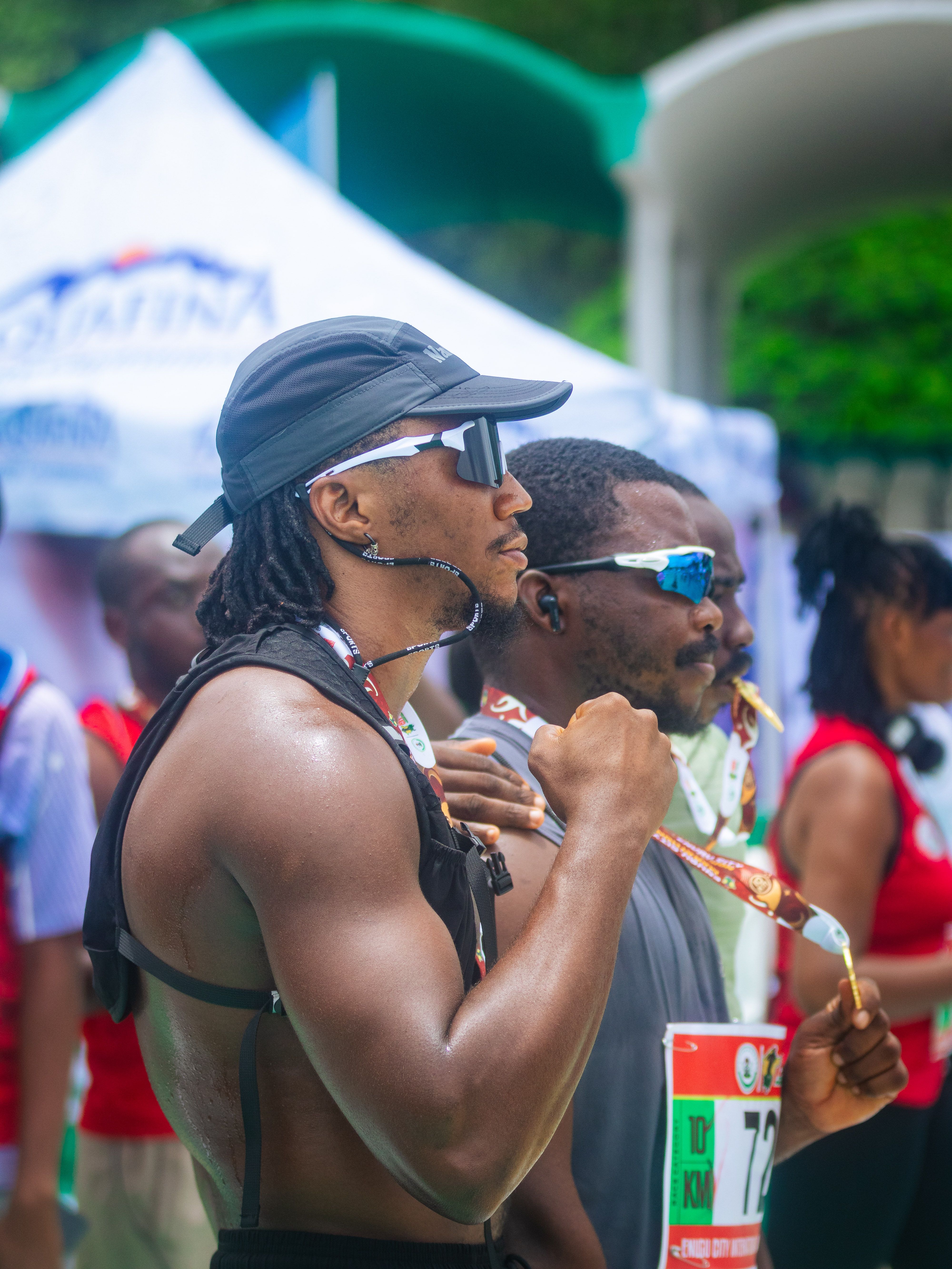 Athlete holding a medal after finishing a marathon, showcasing accomplishment and pride.