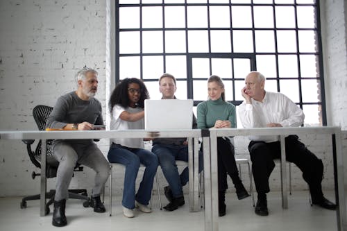 Free Group Of People Looking At The Laptop Stock Photo