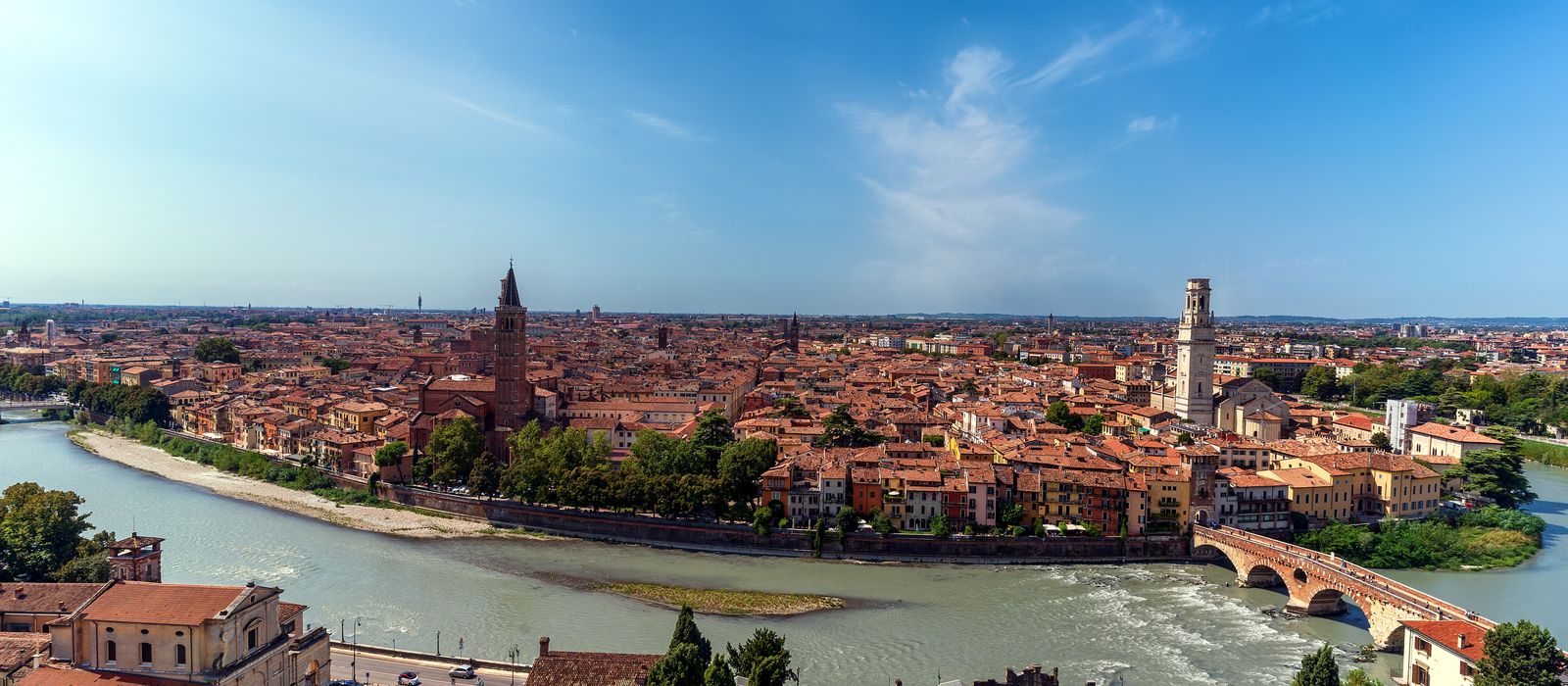 Stunning aerial view of Verona cityscape, featuring the Adige River winding through historic architecture under a clear blue sky. — flights from Catania to Verona