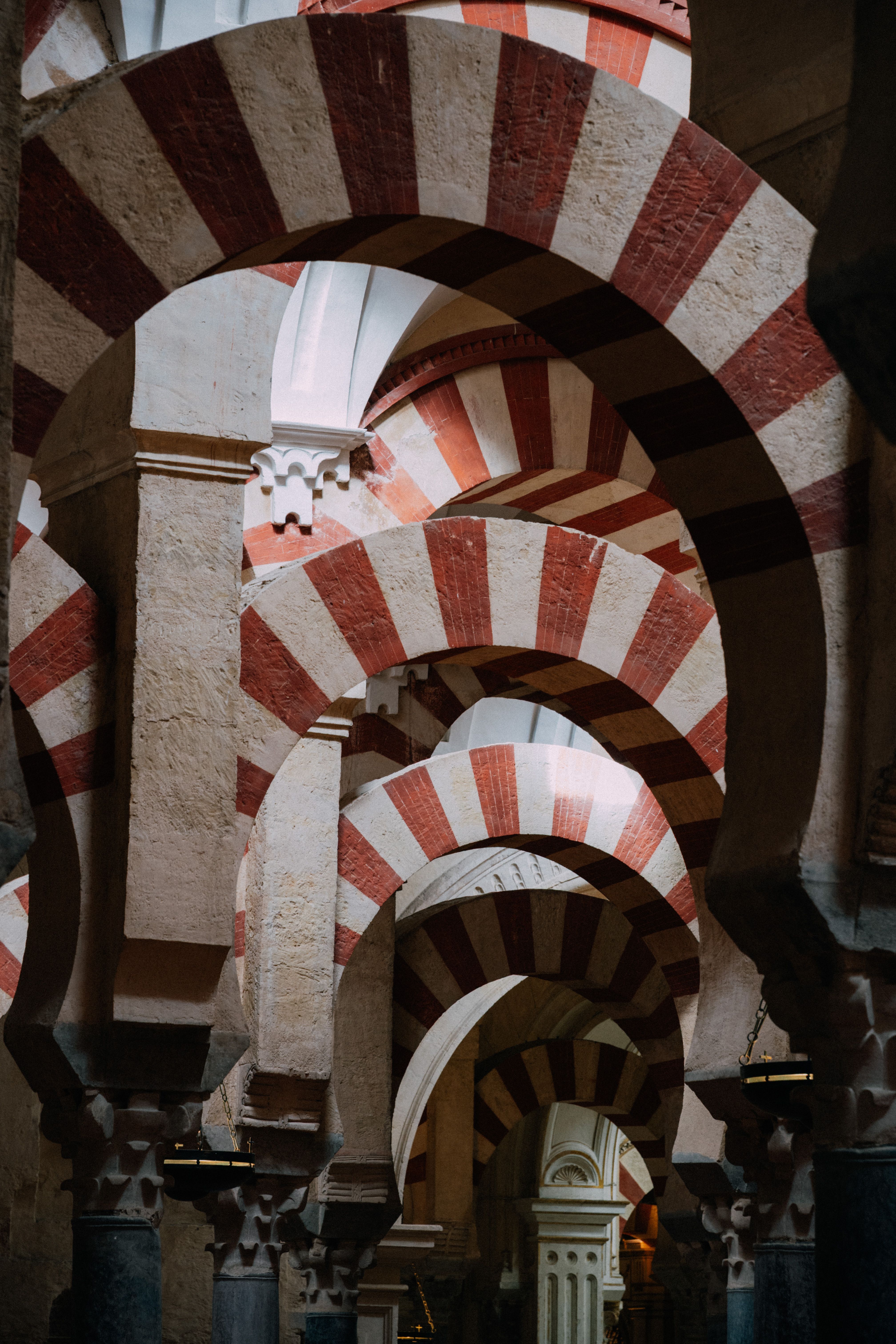 Explore the stunning Moorish arches in the Mezquita of Córdoba, Spain, a masterpiece of Islamic architecture.