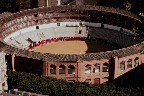 Free Aerial view of the historic Málaga bullring in Andalucía, capturing its architectural beauty. Stock Photo