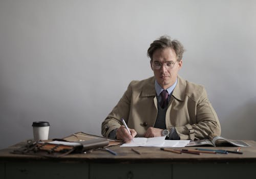 Man in Brown Suit Jacket Working In The Office