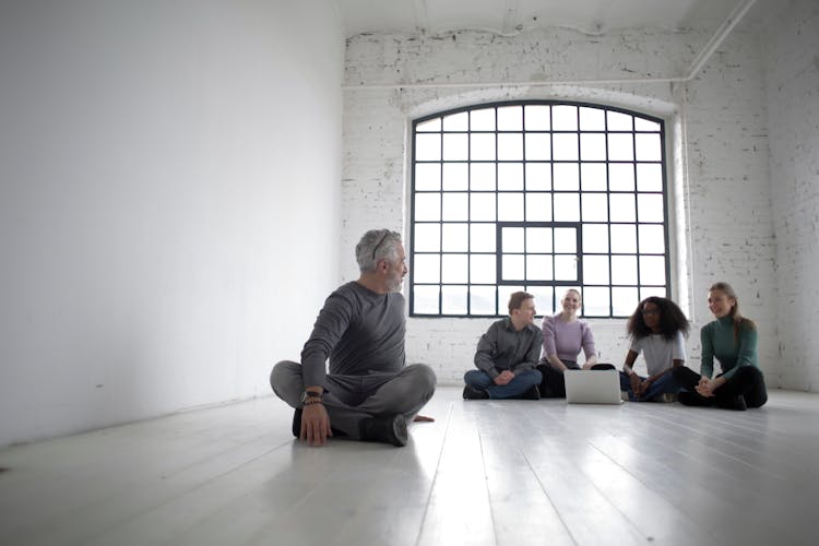 Multiethnic Coworkers Of Different Ages Gathering Before Team Building In Spacious Workspace