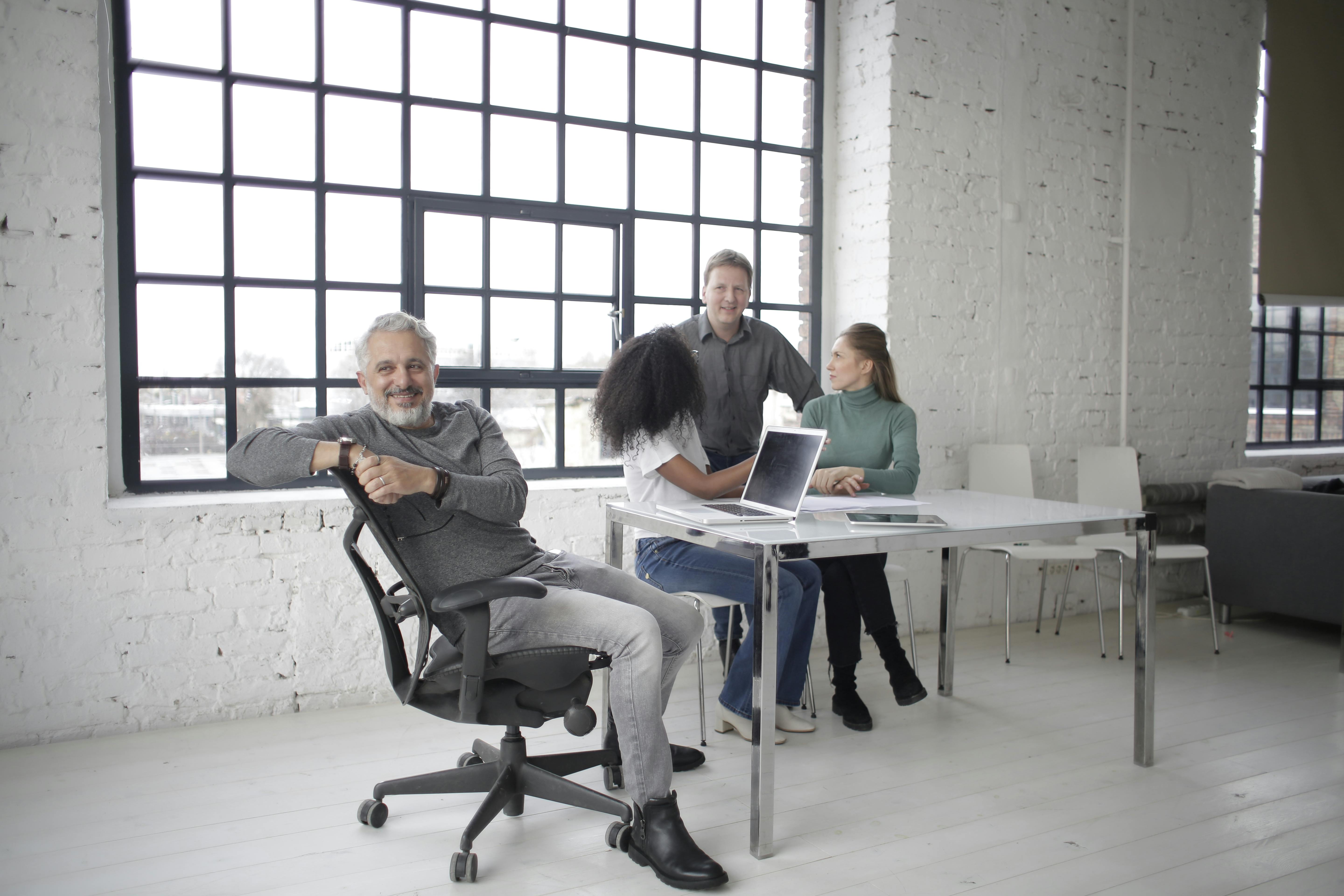 happy-diverse-coworkers-talking-while-having-break-together-in-office