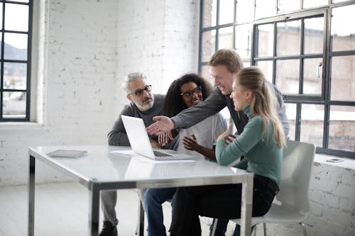 Photo of People Sitting Near Table