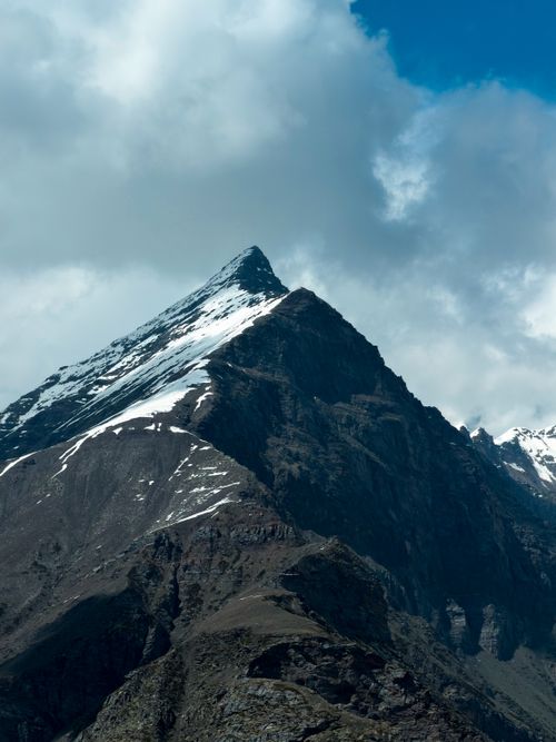 Free Stunning view of a snow-capped mountain peak under a cloudy sky in Himachal Pradesh, India. Stock Photo