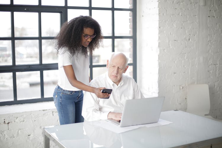 Young Black Woman Showing Smartphone To Boss