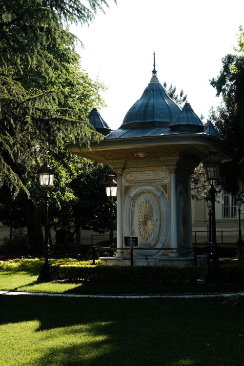 Free Beautiful historic gazebo surrounded by lush greenery in a serene garden setting. Stock Photo