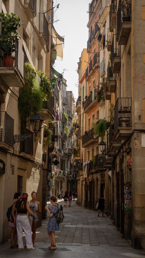 Free A picturesque street in Barcelona with tourists exploring the historic architecture. Stock Photo