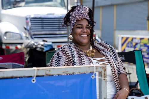 Free A cheerful woman in colorful attire at a vibrant parade in Limón, Costa Rica. Stock Photo