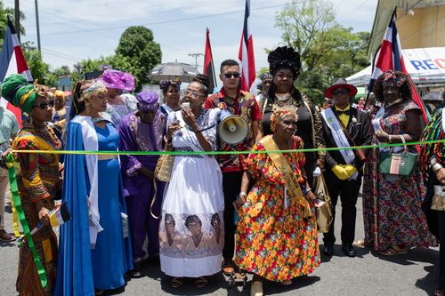 Free Vibrant parade in Limón, Costa Rica, showcasing traditional attire and cultural heritage. Stock Photo