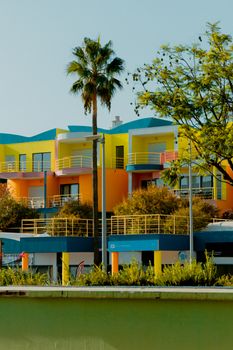 Colorful modern architecture in Faro, Portugal under a clear sky.