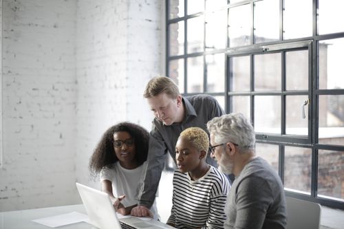 Free A diverse team of adults engaging in a collaborative discussion in an office setting. Stock Photo